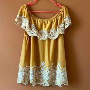 Mustard yellow off the shoulder top with white details.